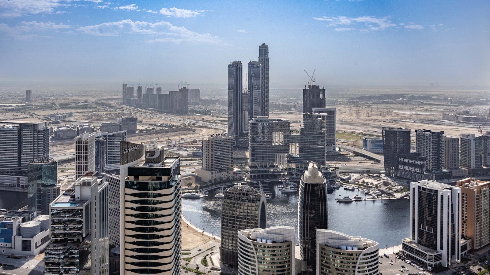 Aerial view of the Business Bay canal district in Dubai, lined with high-rise towers