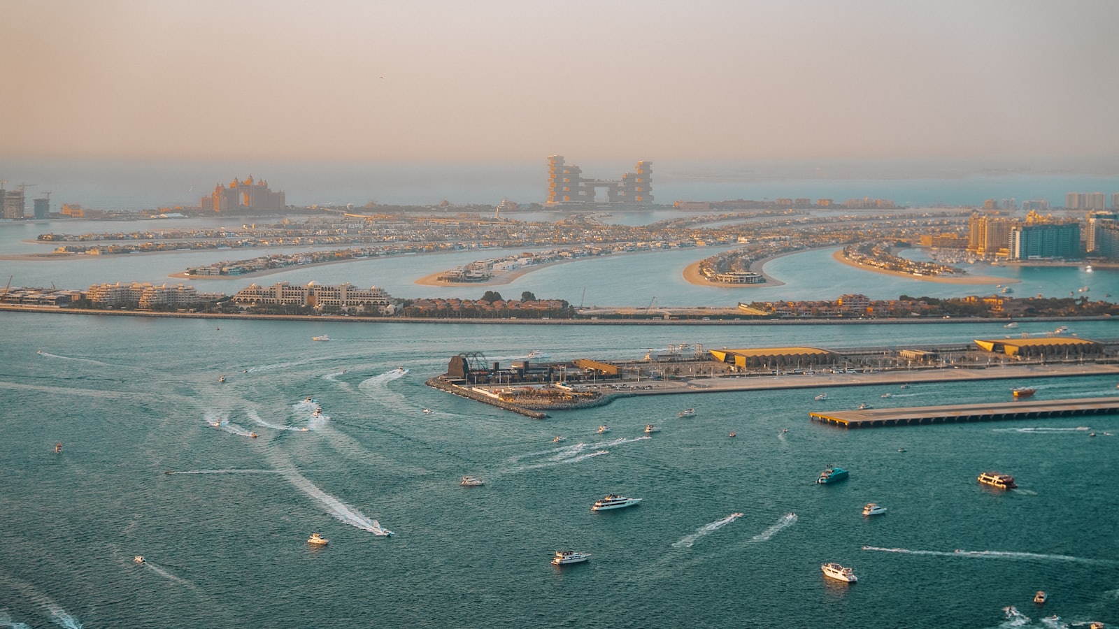 Aerial view of Palm Jumeirah island and its fronds at golden hour
