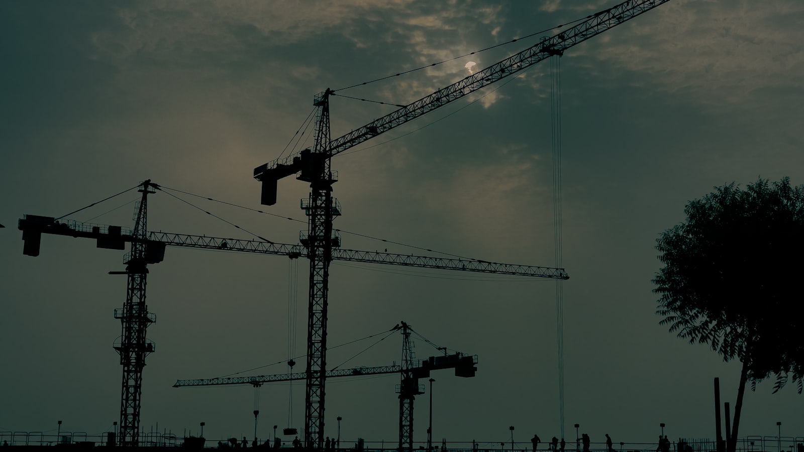 Construction cranes on a Dubai development at dusk